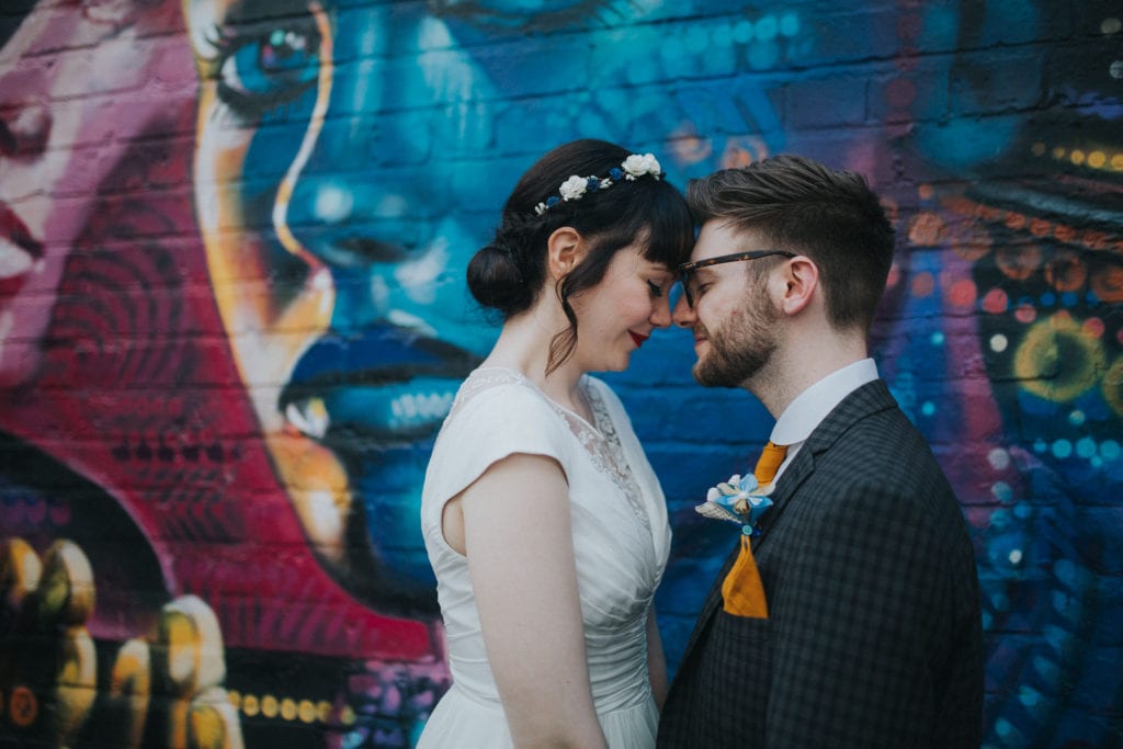 bride and groom in front of graffiti at custard factory wedding in Birmingham 