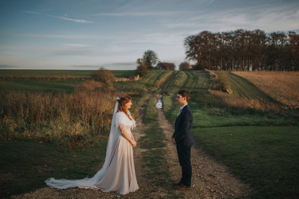 bride and groom in a field during relaxed Cotswold wedding