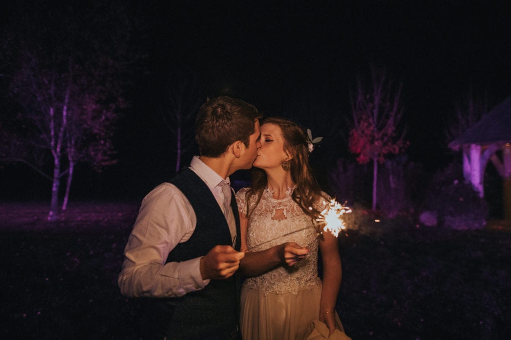 bride and groom with sparklers during winter wedding at Cripps Stone Barn