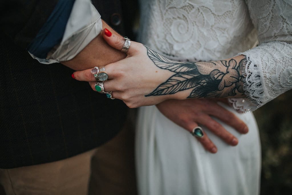 tattooed bride with wedding rings