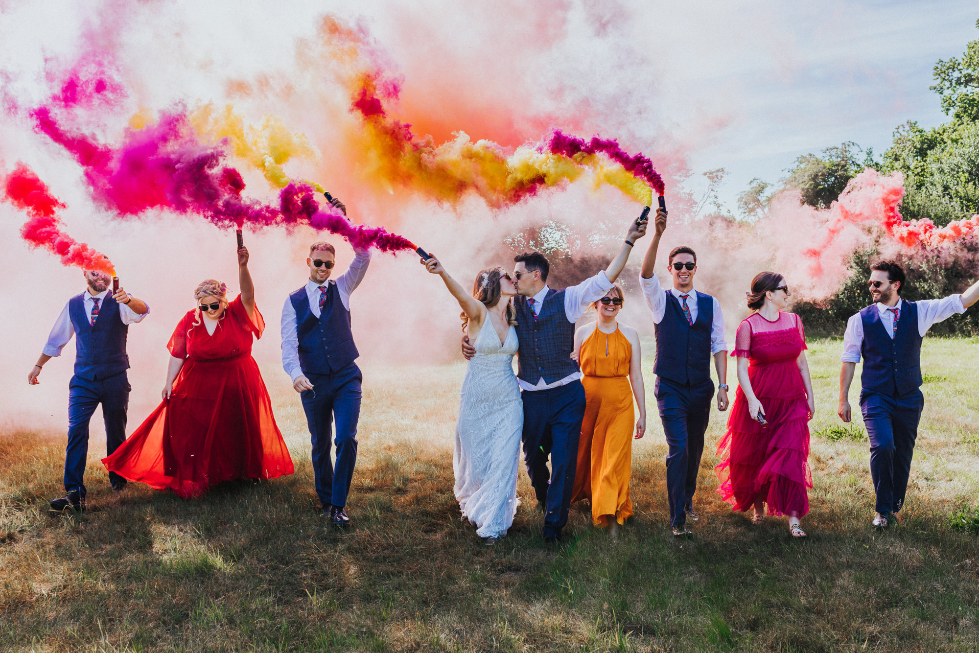 Bridal party with smoke bombs during relaxed festival wedding