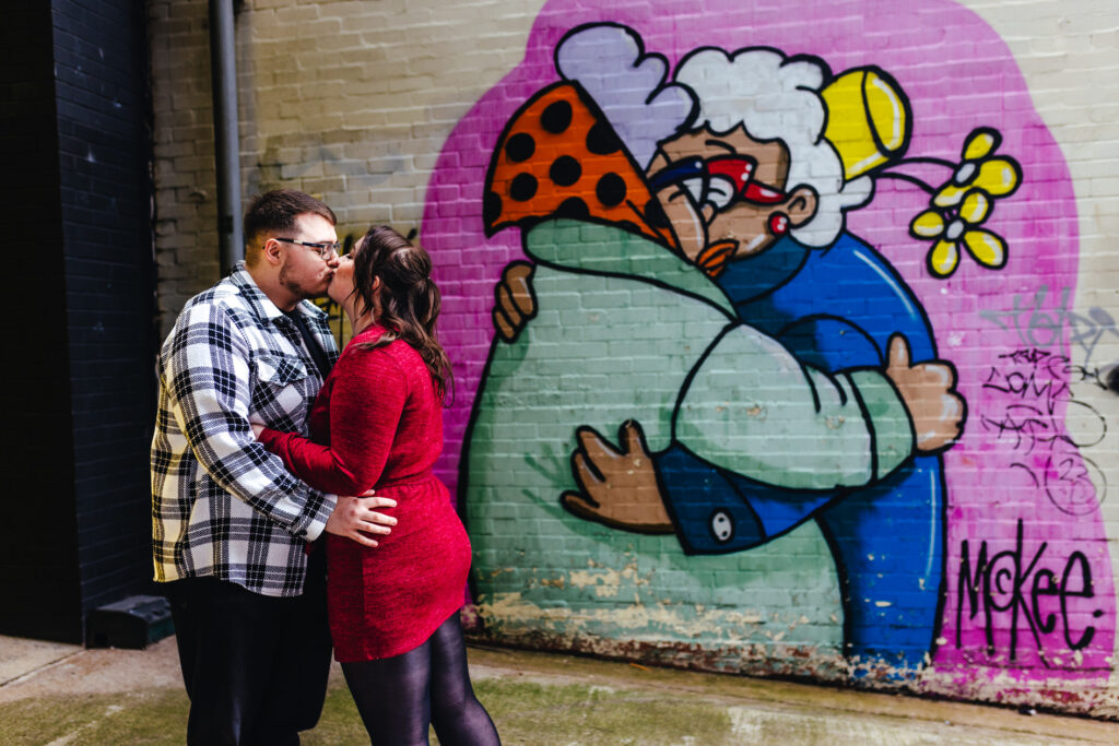 relaxed engagement photograph against colourful graffiti at Digbeth, Birmingham.