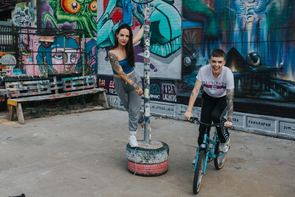 relaxed engagement photograph against colourful graffiti at Digbeth, Birmingham.