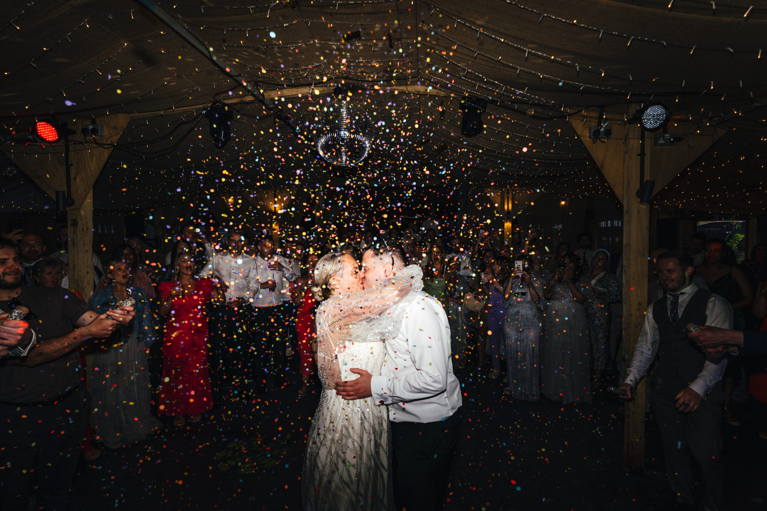 bride and groom on dancefloor with confetti canons at rhyse farm